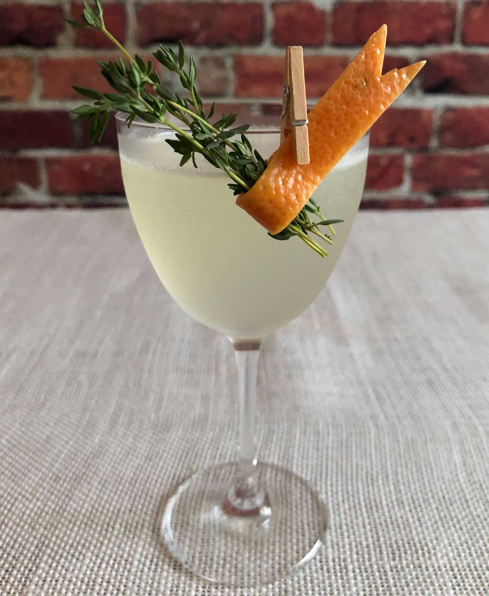 An example of the Hemingway in Europe, the mixed drink (cocktail), by Patrick Williams, Punch Bowl Social, Denver, featuring Batavia Arrack van Oosten, grapefruit oleo-saccharum, lime juice, and maraschino liqueur; photo by Lee Edwards