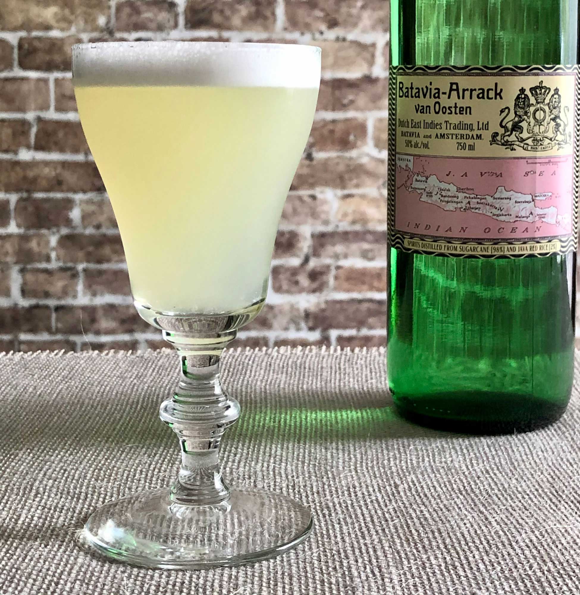 An example of the Arrack Sour, the mixed drink (sour), by Lane Ford, SF, featuring Batavia Arrack van Oosten, egg white, lemon juice, maraschino liqueur, gum syrup, and Peychaud’s Aromatic Cocktail Bitters; photo by Lee Edwards