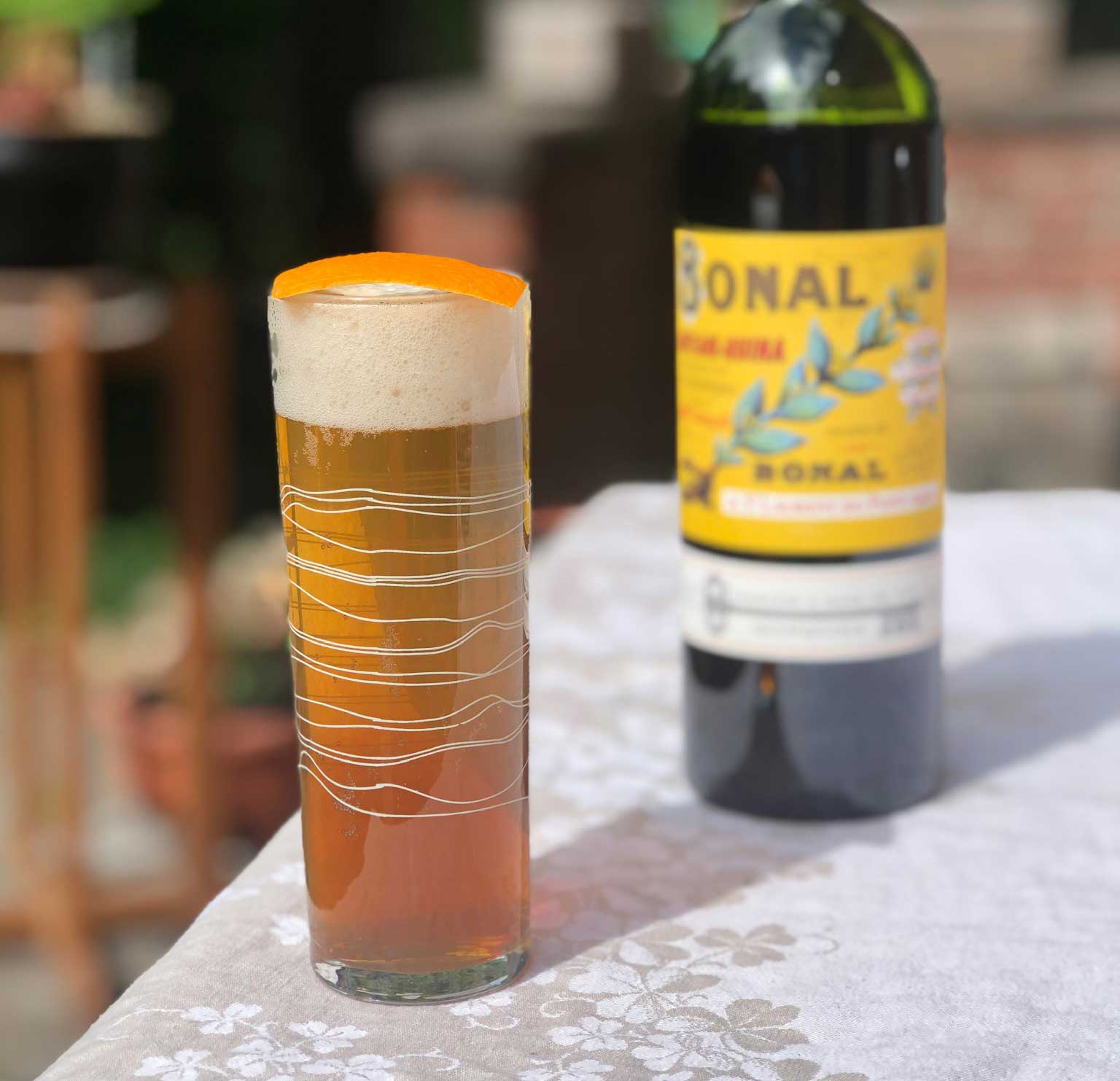 An example of the Amer Frontière, the mixed drink (cocktail) featuring lager, Bonal Gentiane-Quina, and orange bitters