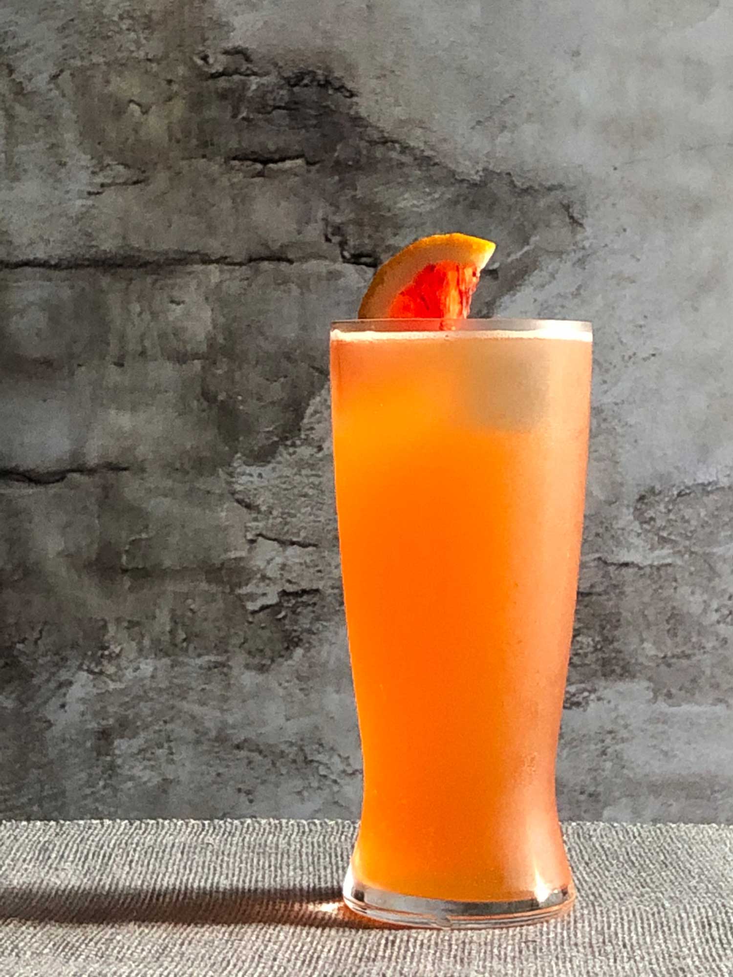 An example of the The Roadie, the mixed drink (cocktail), by Booth Hardy, Barrel Thief Wine Shop & Café, Richmond, VA. In honor of the 2015 World Road Cycling Championships, featuring Stiegl Grapefruit Radler, and Aperitivo Cappelletti; photo by Lee Edwards