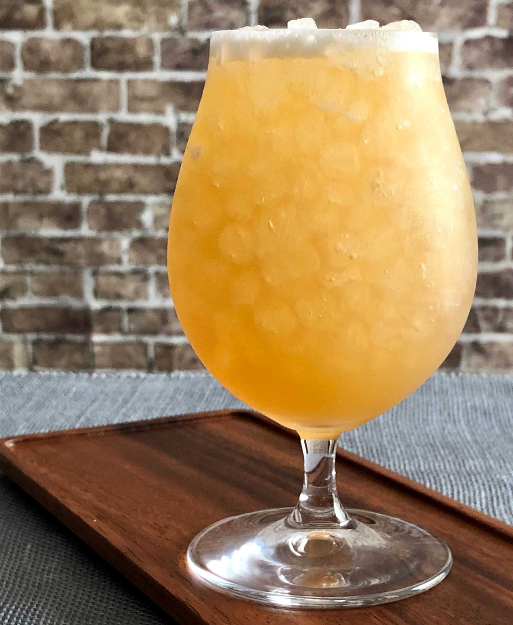 An example of the Sawbuck, the mixed drink (cocktail), by Kirkland Tap & Trotter, Cambridge, MA, featuring india pale ale, rye whiskey, cinnamon-infused sugar syrup, lemon juice, and Nux Alpina Walnut Liqueur; photo by Lee Edwards