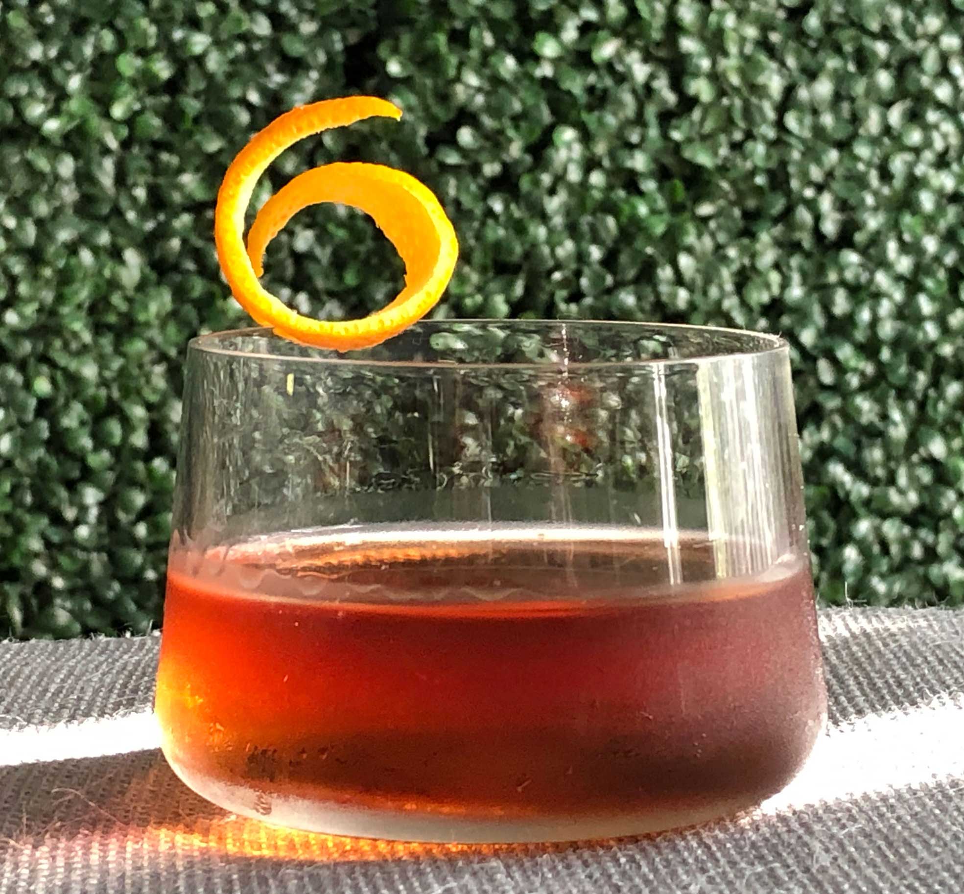 An example of the Pat’s Old Friend, the mixed drink (cocktail), adapted from the Pat’s Special, Savoy Cocktail Book, featuring Bonal Gentiane-Quina, Hayman’s Old Tom Gin, Mas Peyre Rancio Sec “Le Démon de Midi”, grenadine, and Rothman & Winter Orchard Apricot Liqueur; photo by Lee Edwards
