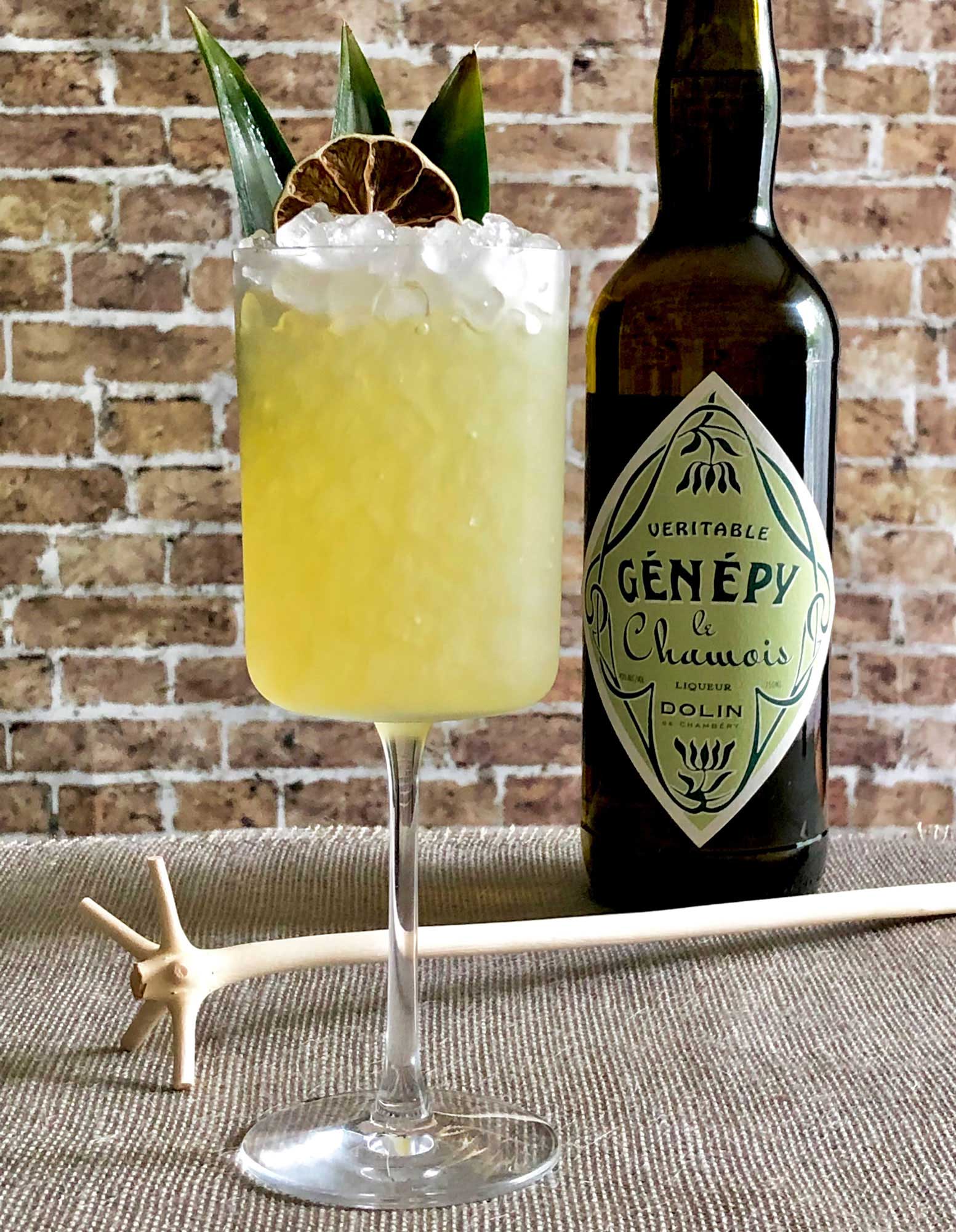 An example of the Génépy Swizzle, the mixed drink (frappe), by Based on the Chartreuse Swizzle by Marcovaldo Dionysos, San Francisco, California, featuring Dolin Génépy le Chamois Liqueur, pineapple juice, John D. Taylor’s Velvet Falernum, lime juice, and mezcal; photo by Lee Edwards