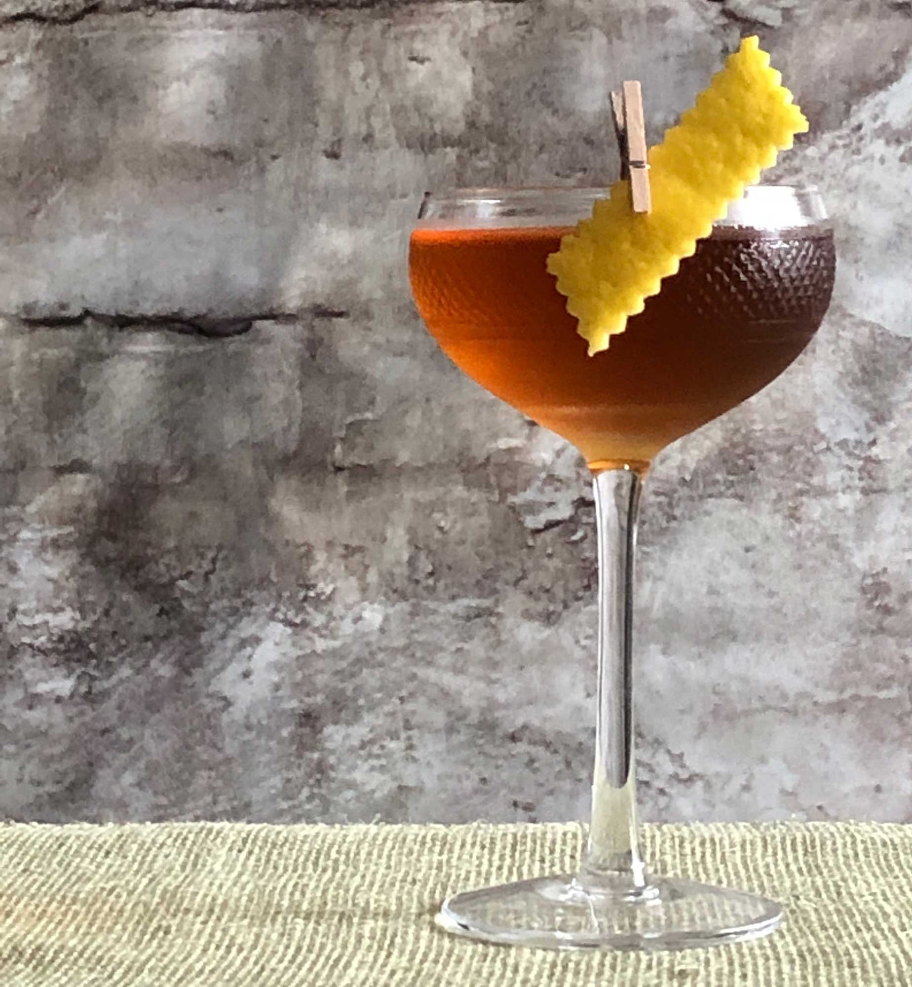 An example of the Jewel Cocktail, the mixed drink (cocktail) featuring Dolin Génépy le Chamois Liqueur, Hayman’s London Dry Gin, Cocchi Vermouth di Torino ‘Storico’, and orange bitters; photo by Lee Edwards