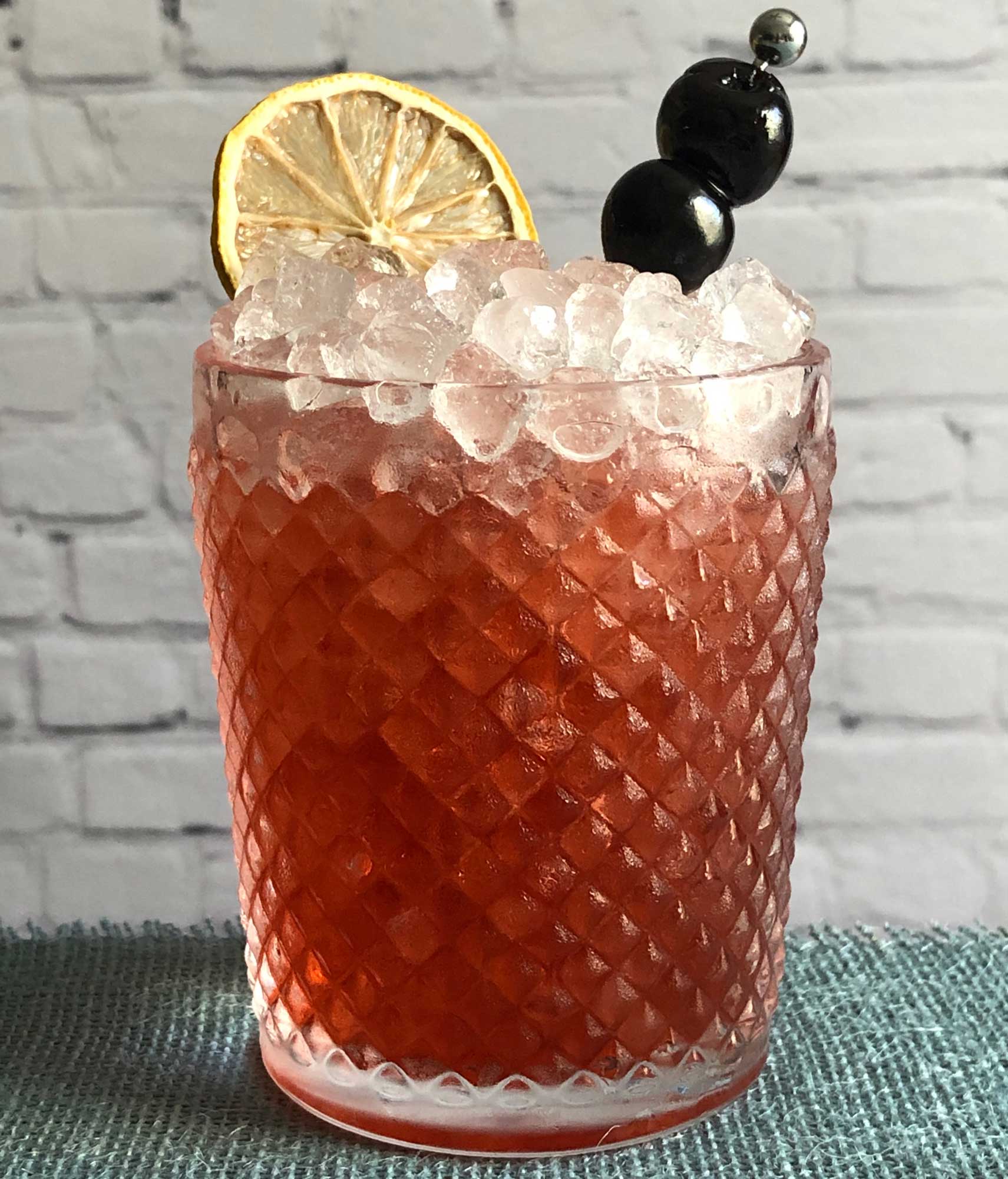 An example of the Cheerwine Swizzle, the mixed drink (frappe), by David Burnette, South on Main, Little Rock, Arkansas, featuring Cheerwine, Dolin Génépy le Chamois Liqueur, and lemon juice; photo by Lee Edwards