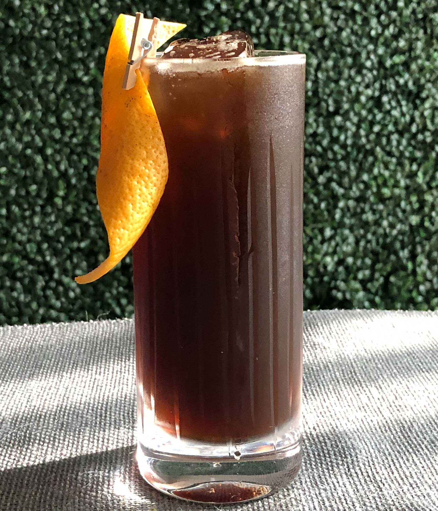 An example of the Poker Face, the mixed drink (cocktail) featuring Fentimans Curiosity Cola, Elisir Novasalus, Salers Gentian Apéritif, and Zirbenz Stone Pine Liqueur of the Alps; photo by Lee Edwards