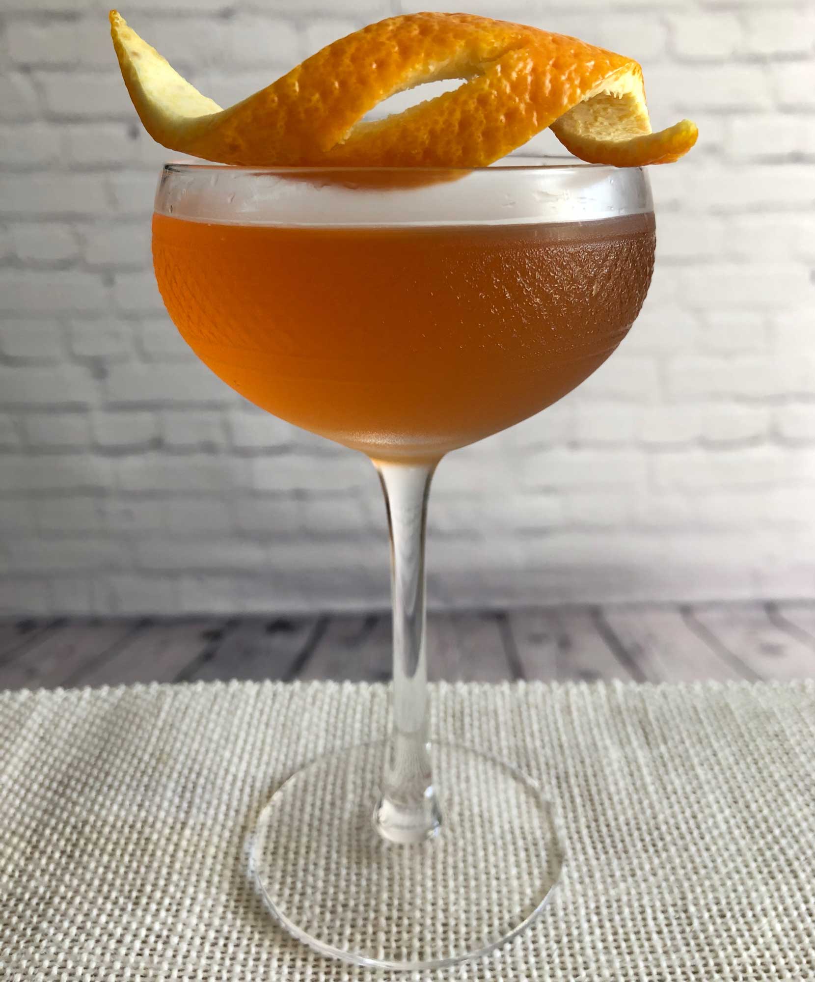 An example of the Boomerang Cocktail, the mixed drink (cocktail), by Savoy Cocktail Book, featuring KRONAN Swedish Punsch, rye whiskey, Dolin Dry Vermouth de Chambéry, lemon juice, Angostura bitters, and orange bitters; photo by Lee Edwards