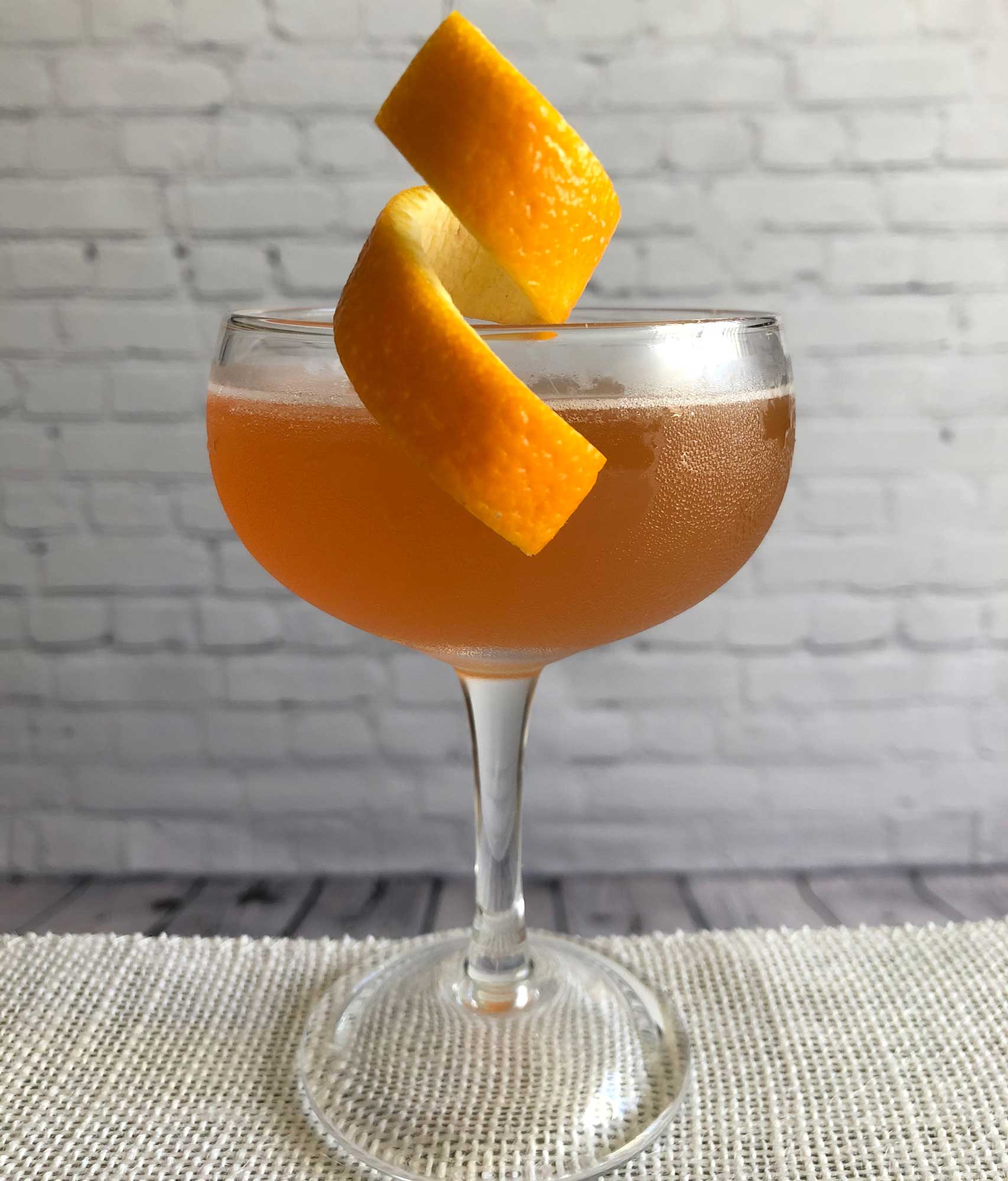 An example of the Diki-Diki, the mixed drink (cocktail), by Savoy Cocktail Book, featuring calvados, KRONAN Swedish Punsch, grapefruit juice, and simple syrup; photo by Lee Edwards