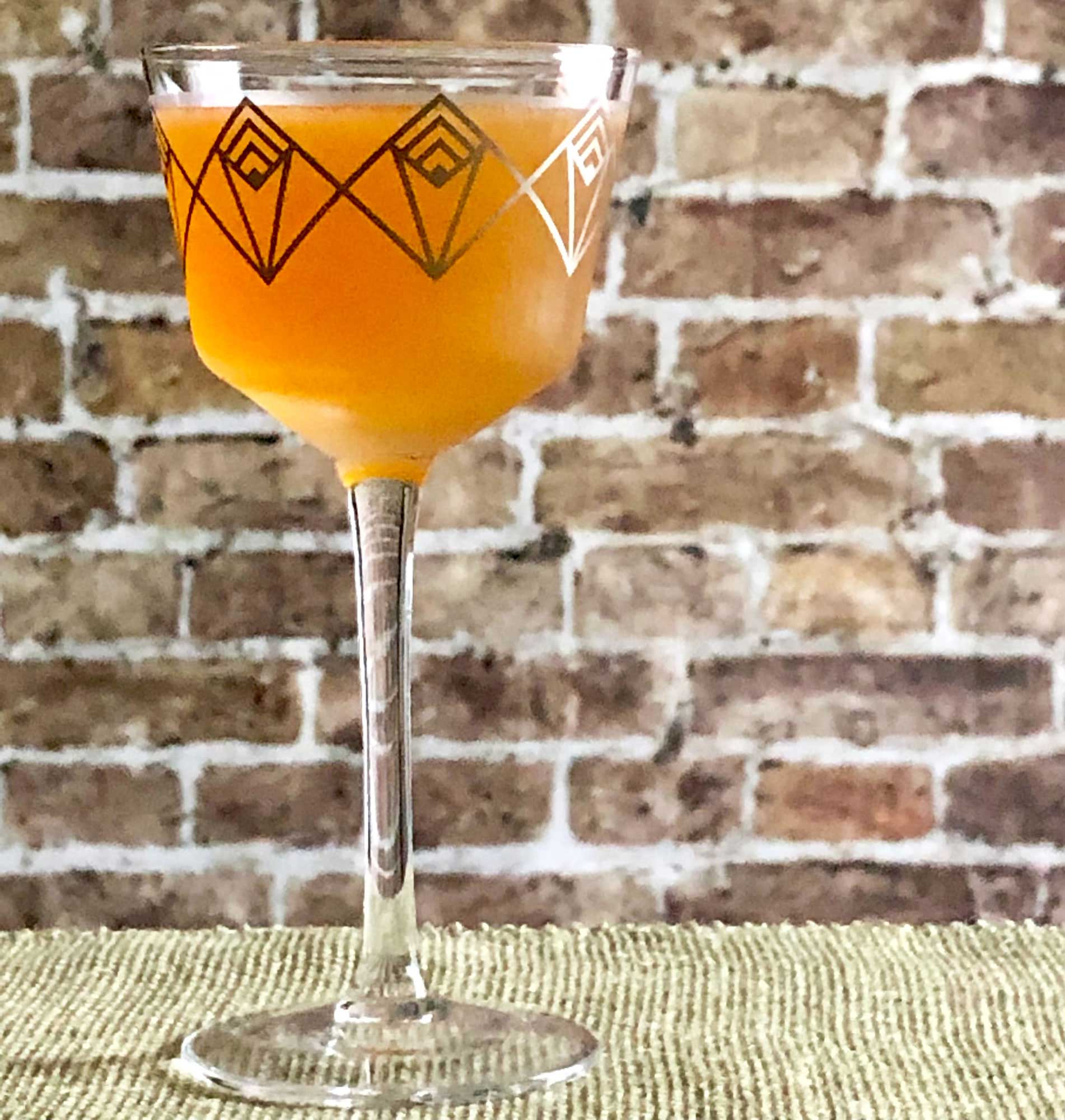 An example of the Melba Cocktail, the mixed drink (cocktail), adapted from a recipe in the Savoy Cocktail Book:, featuring KRONAN Swedish Punsch, light rum, lime juice, and lemon juice; photo by Lee Edwards