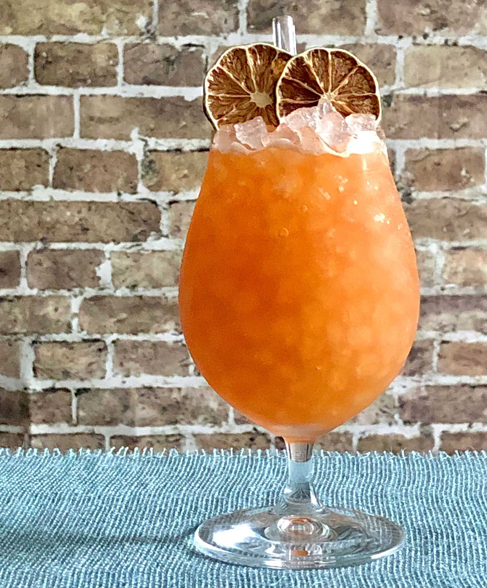 An example of the Anna Skytte’s Raid, the mixed drink (cocktail), by Luiggi Uzcategui, Big Orange, Little Rock, AR, featuring KRONAN Swedish Punsch, rye whiskey, lime juice, Smith & Cross Traditional Jamaica Rum, Carlsbad Becherovka Bitter, Angostura bitters, and St. Elizabeth Allspice Dram; photo by Lee Edwards