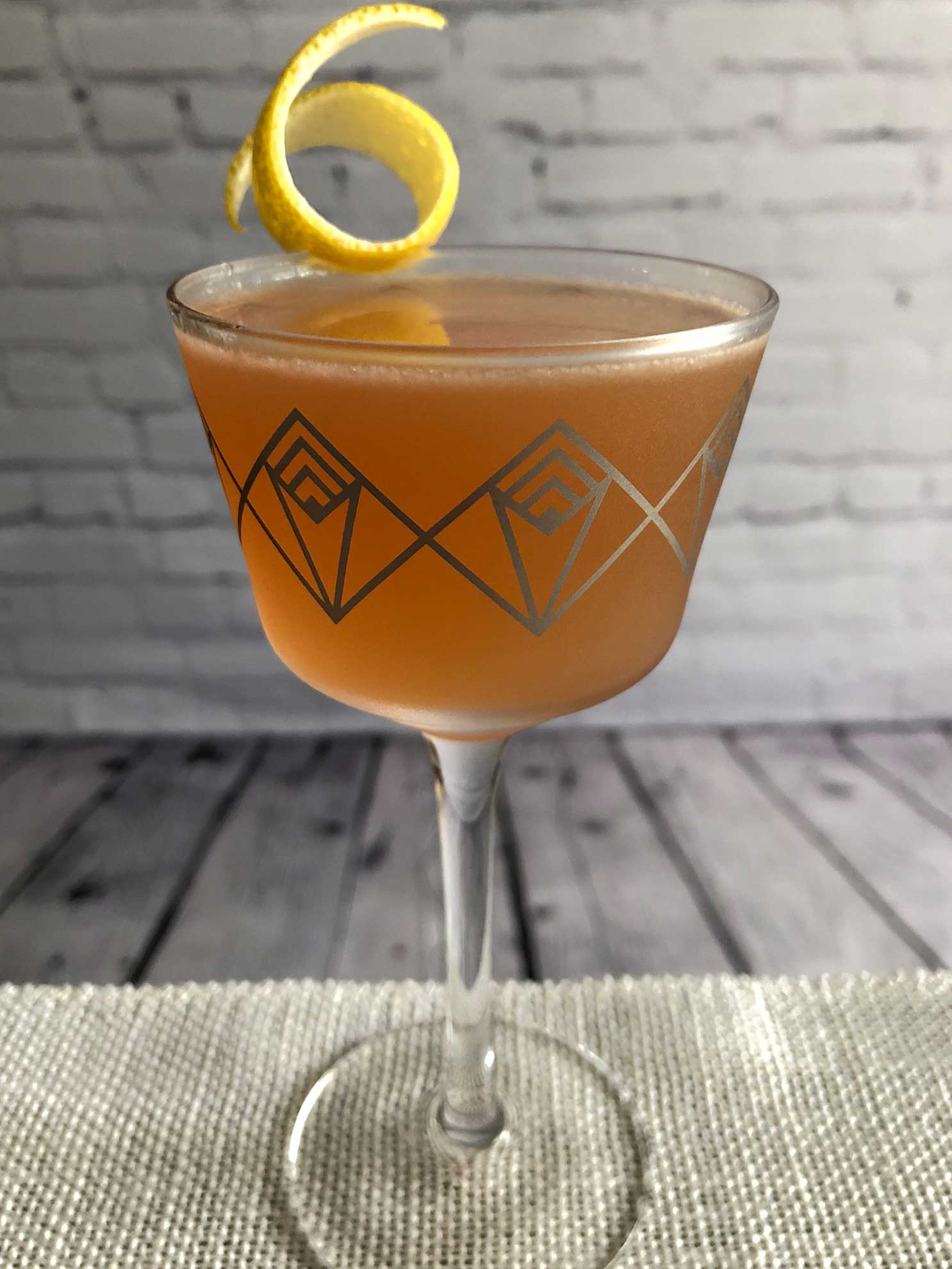 An example of the Jazz Flute, the mixed drink (cocktail), by riff on Gilchrist, PDT book, featuring scotch whisky, Purkhart Pear Williams Eau-de-Vie, pink grapefruit juice, Cardamaro Vino Amaro, simple syrup, and grapefruit bitters; photo by Lee Edwards