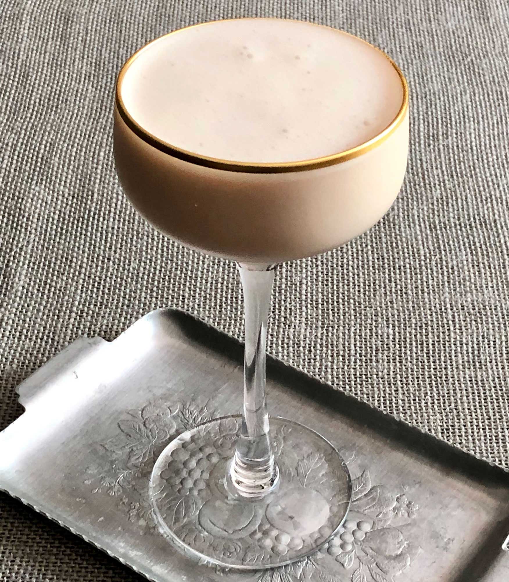 An example of the Juneau Suisse, the mixed drink (cocktail) featuring Purkhart Pear Williams Eau-de-Vie, cream, Dolin Génépy le Chamois Liqueur, Nux Alpina Walnut Liqueur, Angostura bitters, and crème de cacao (white); photo by Lee Edwards