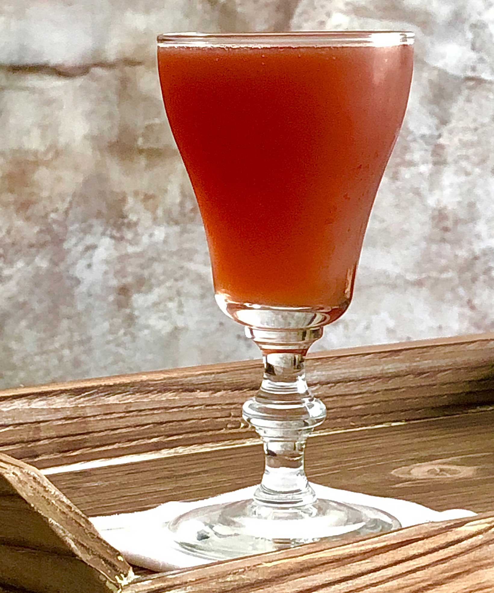 An example of the Plum Billet, the mixed drink (cocktail), variation on the Pruneaux cocktail, Savoy Cocktail Book, featuring Hayman’s Royal Dock Navy Strength Gin, Matifoc Rancio Sec, orange juice, Byrrh Grand Quinquina, simple syrup, and Angostura bitters; photo by Lee Edwards