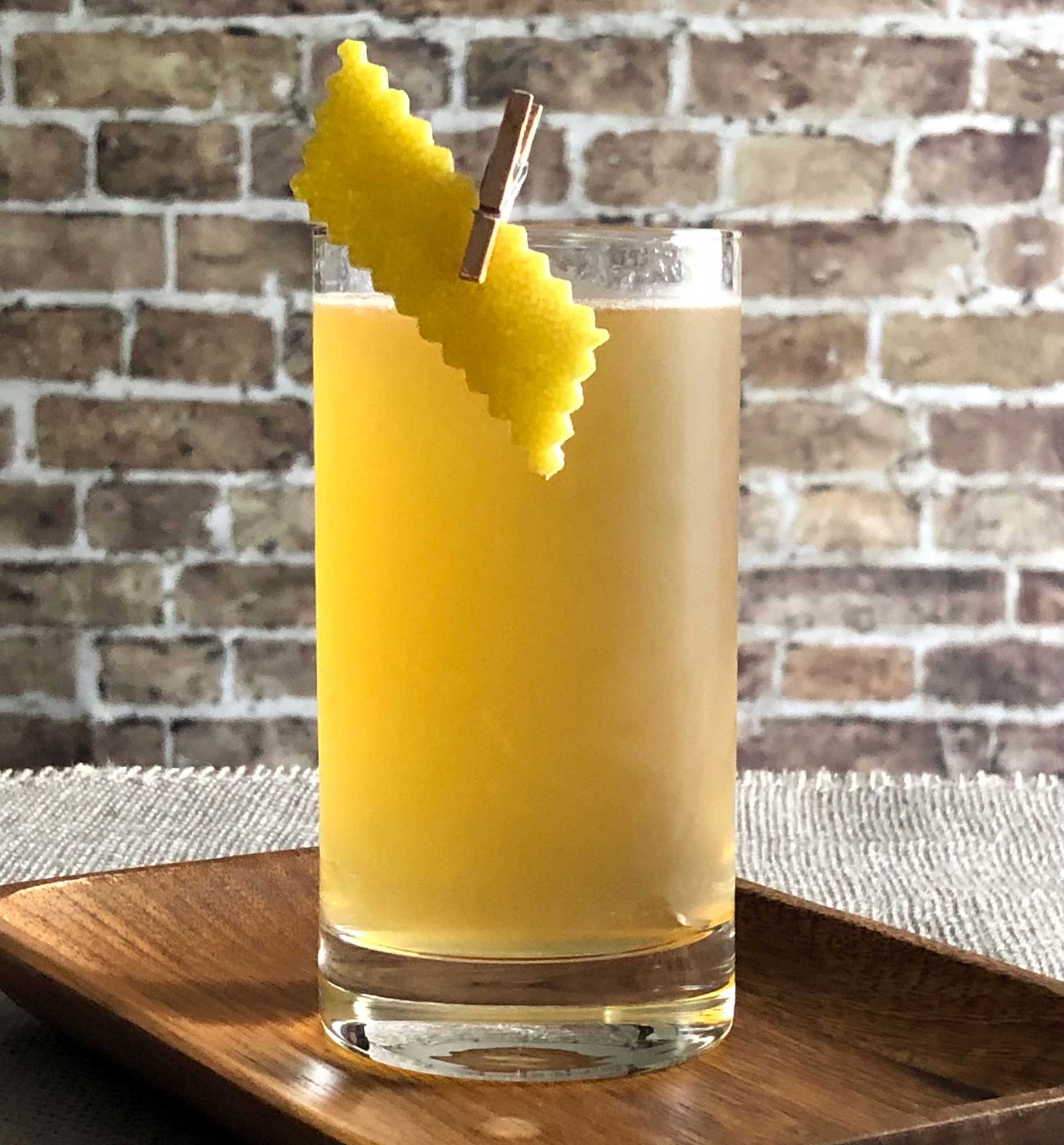 An example of the Apricot Beer Collins, the mixed drink (collins) featuring white beer, Hayman’s Old Tom Gin, Rothman & Winter Orchard Apricot Liqueur, and lemon juice; photo by Lee Edwards