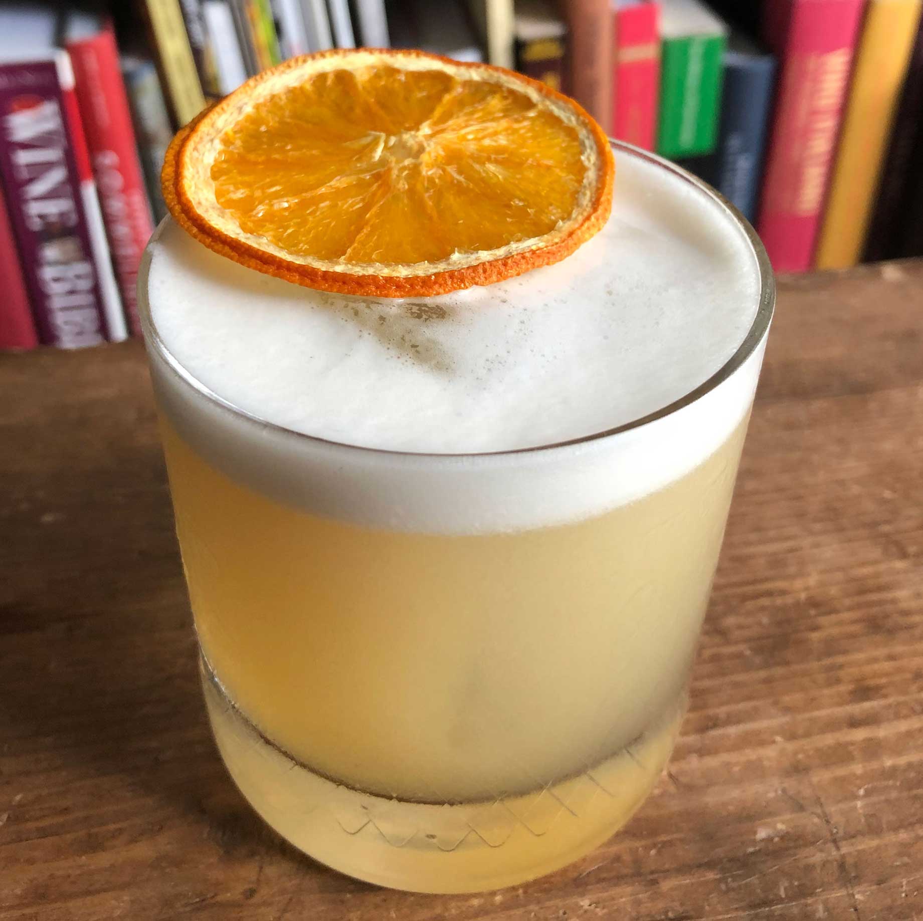 An example of the Peach Whiskey Sour, the mixed drink (sour) featuring bourbon whiskey, Rothman & Winter Orchard Peach Liqueur, egg white, lemon juice, and simple syrup; photo by Lee Edwards