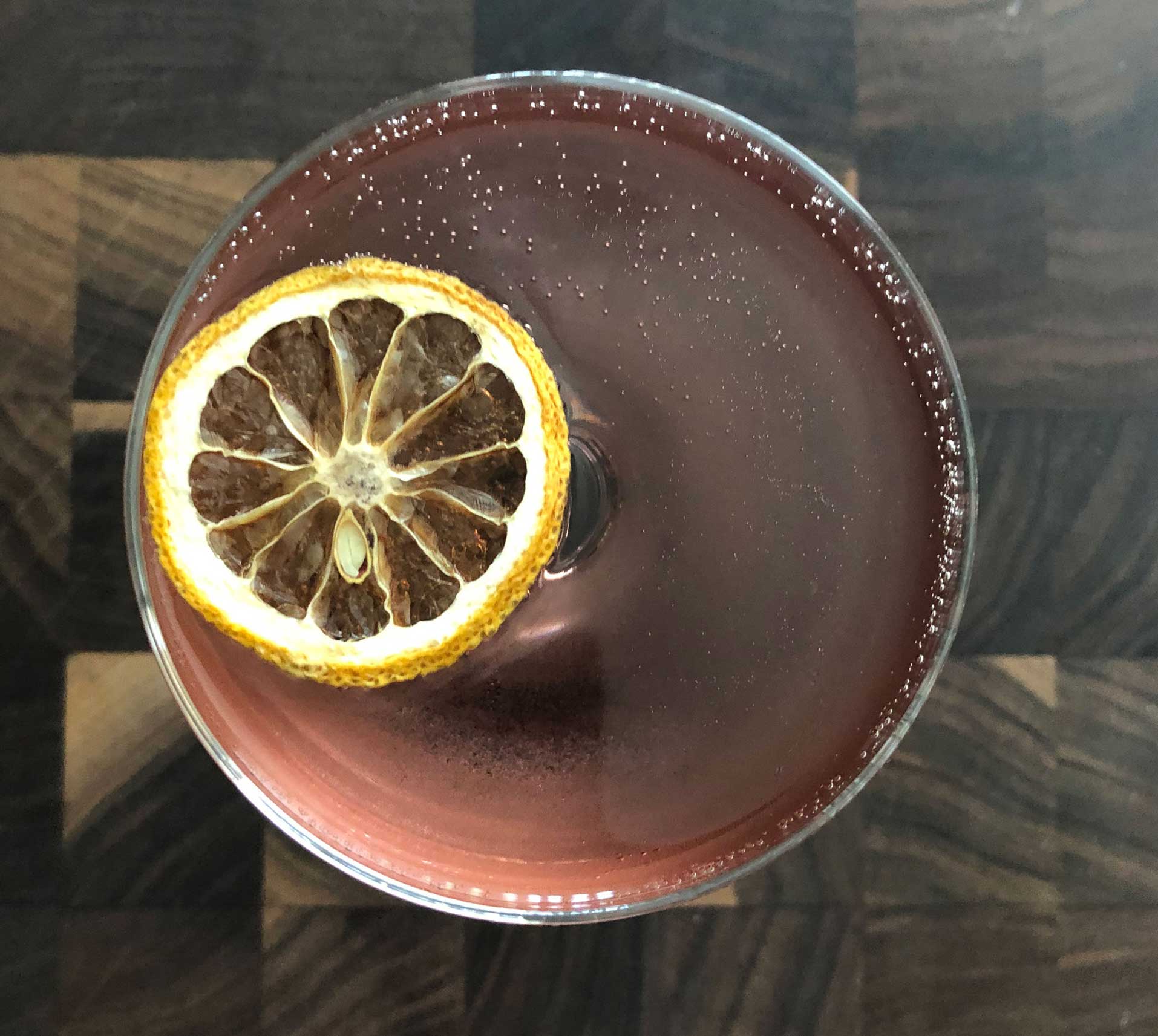 An example of the Prairie Pooch, the mixed drink (cocktail) featuring Hayman’s London Dry Gin, Cocchi Americano Rosa, Dolin Blanc Vermouth de Chambéry, sparkling wine, and Rothman & Winter Crème de Violette; photo by Lee Edwards