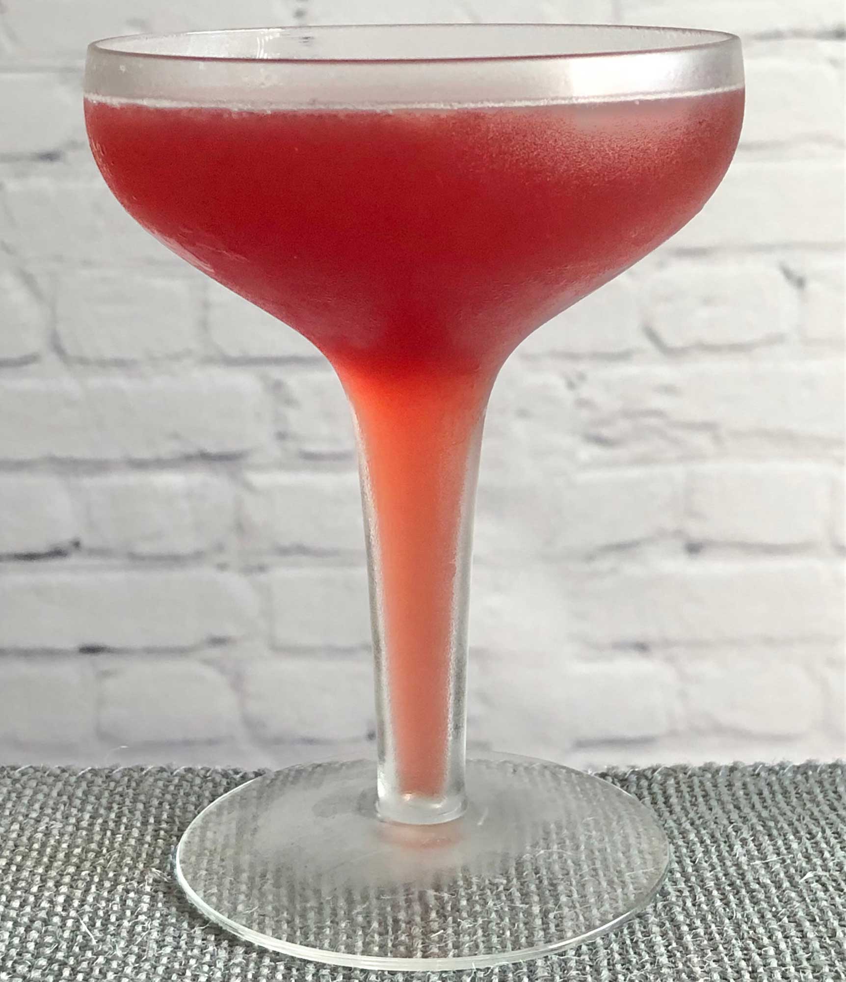 An example of the Robson Cocktail, the mixed drink (cocktail), by Savoy Cocktail Book, featuring Smith & Cross Traditional Jamaica Rum, grenadine, orange juice, lemon juice, and Angostura bitters; photo by Lee Edwards