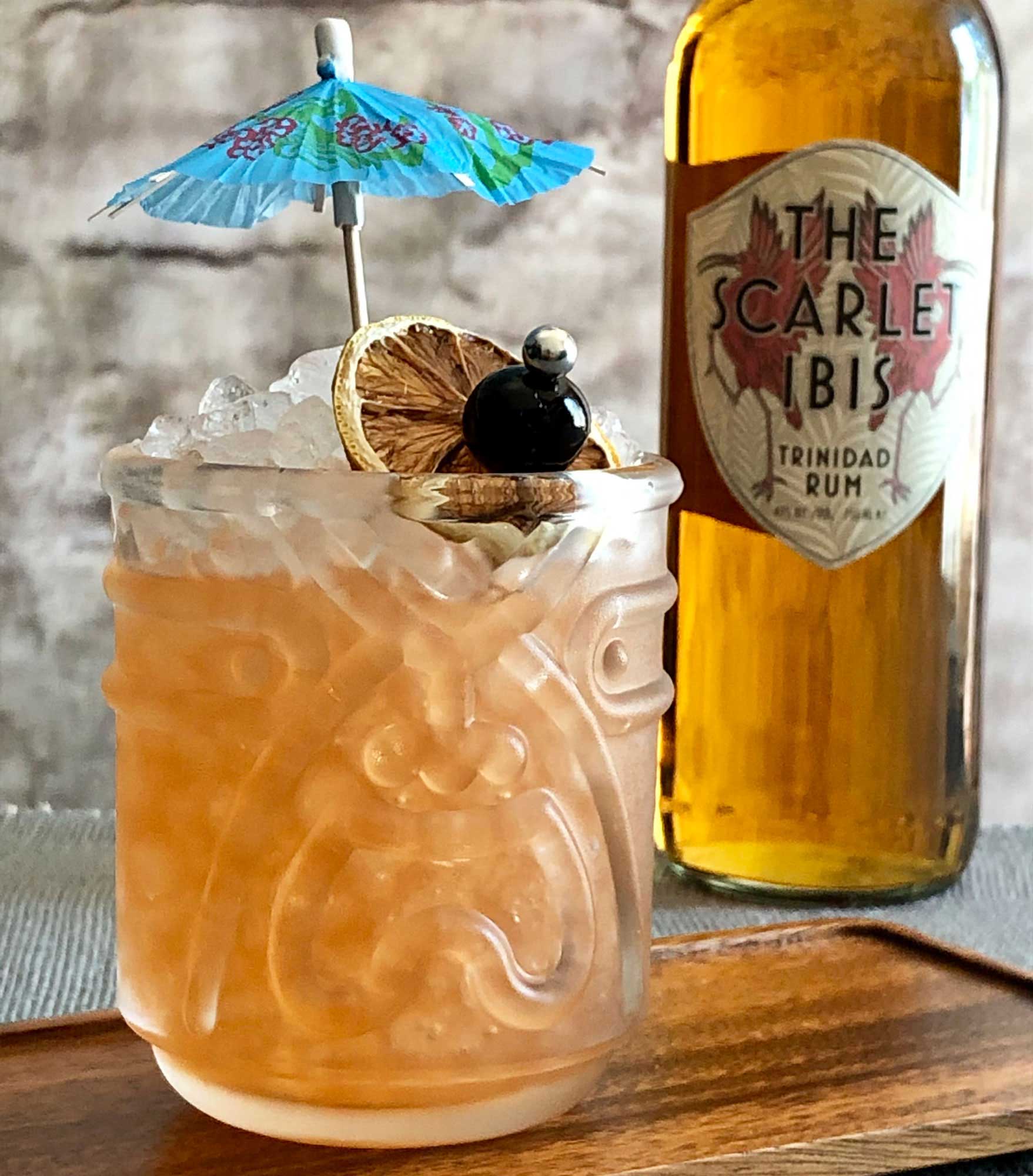 An example of the Test Pilot Punch, the mixed drink (punch), by based on a cocktail by Don the Beachcomber, featuring John D. Taylor’s Velvet Falernum, Smith & Cross Traditional Jamaica Rum, The Scarlet Ibis Trinidad Rum, orange-flavored liqueur, lime juice, pastis, and Angostura bitters; photo by Lee Edwards