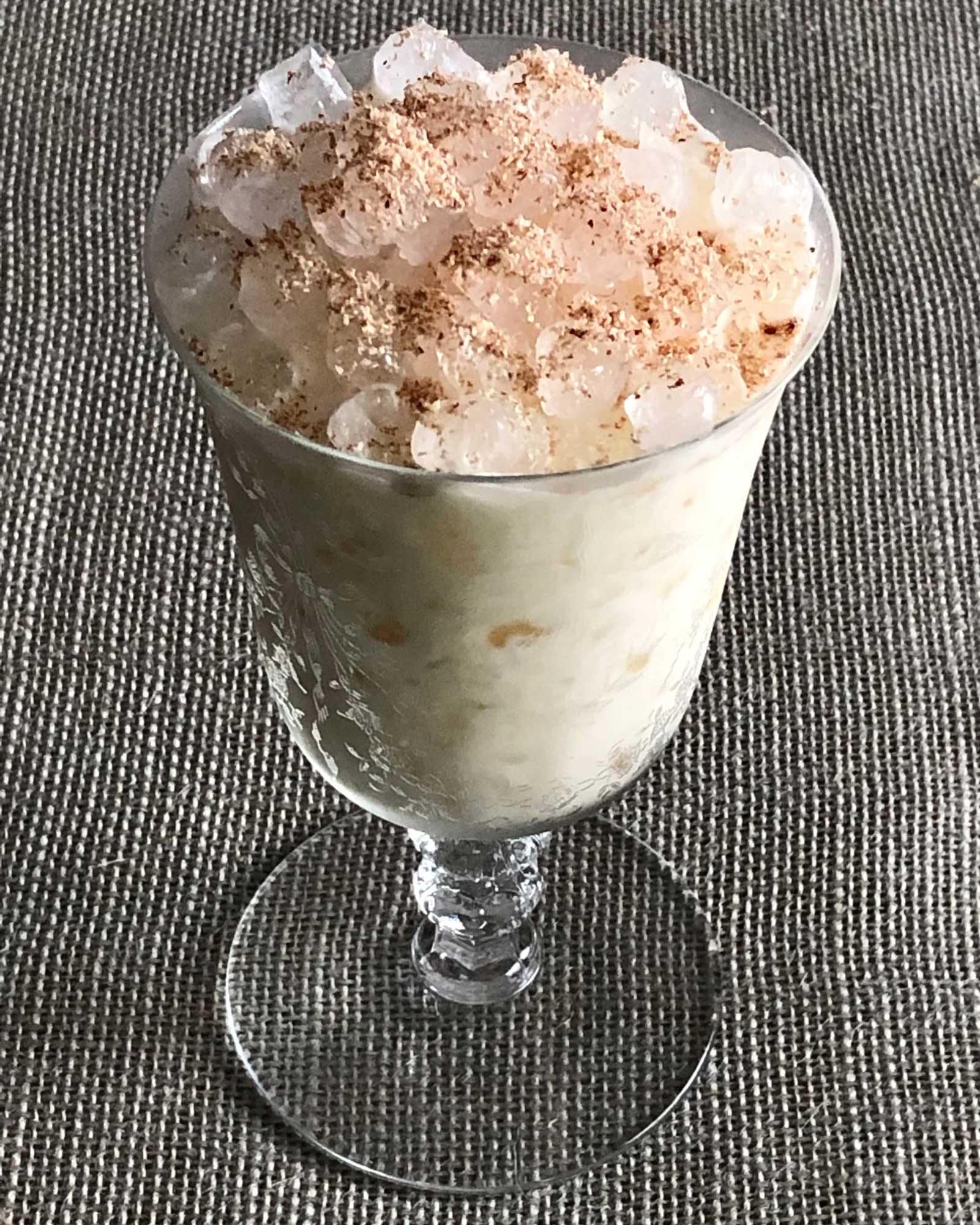 An example of the Caribbean Milk Punch, the mixed drink (punch), by Brennan’s Restaurant, New Orleans, Louisiana, featuring Smith & Cross Traditional Jamaica Rum, vanilla syrup, cream, and bourbon whiskey; photo by Lee Edwards
