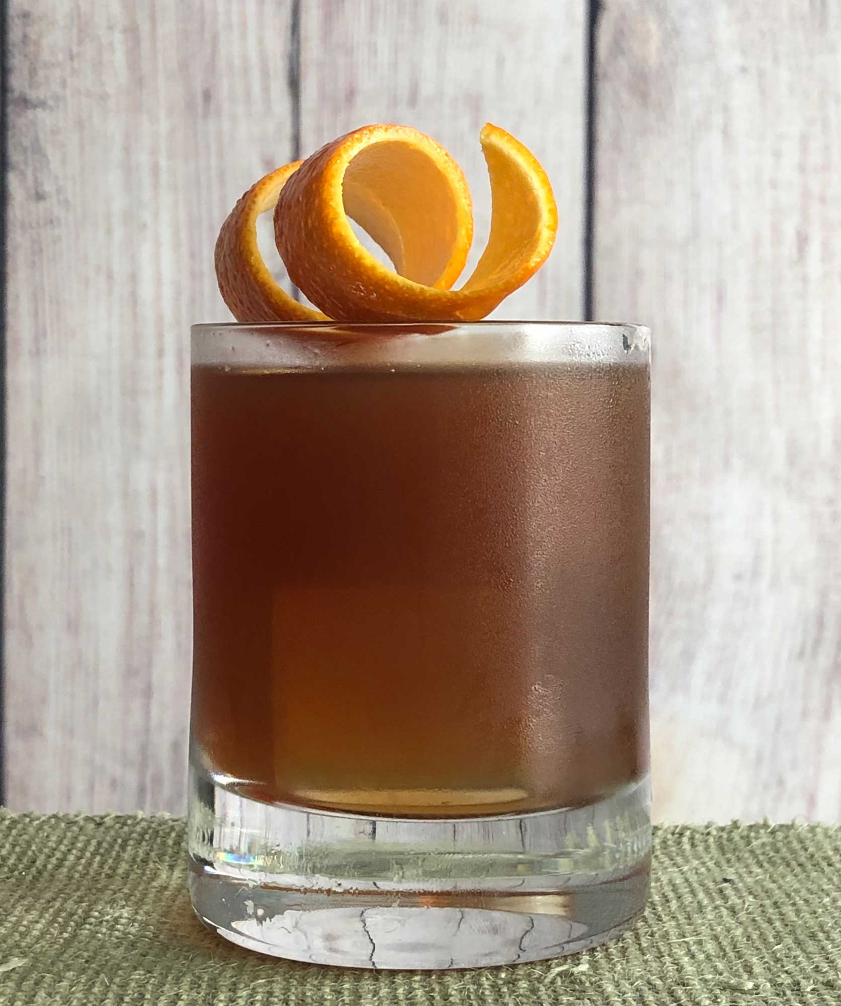 An example of the Sinnerman, the mixed drink (cocktail), variation of a drink by Mike Fleming, Westbridge, Cambridge, MA, featuring Cocchi Vermouth di Torino ‘Storico’, Salers Gentian Apéritif, and St. Elizabeth Allspice Dram; photo by Lee Edwards