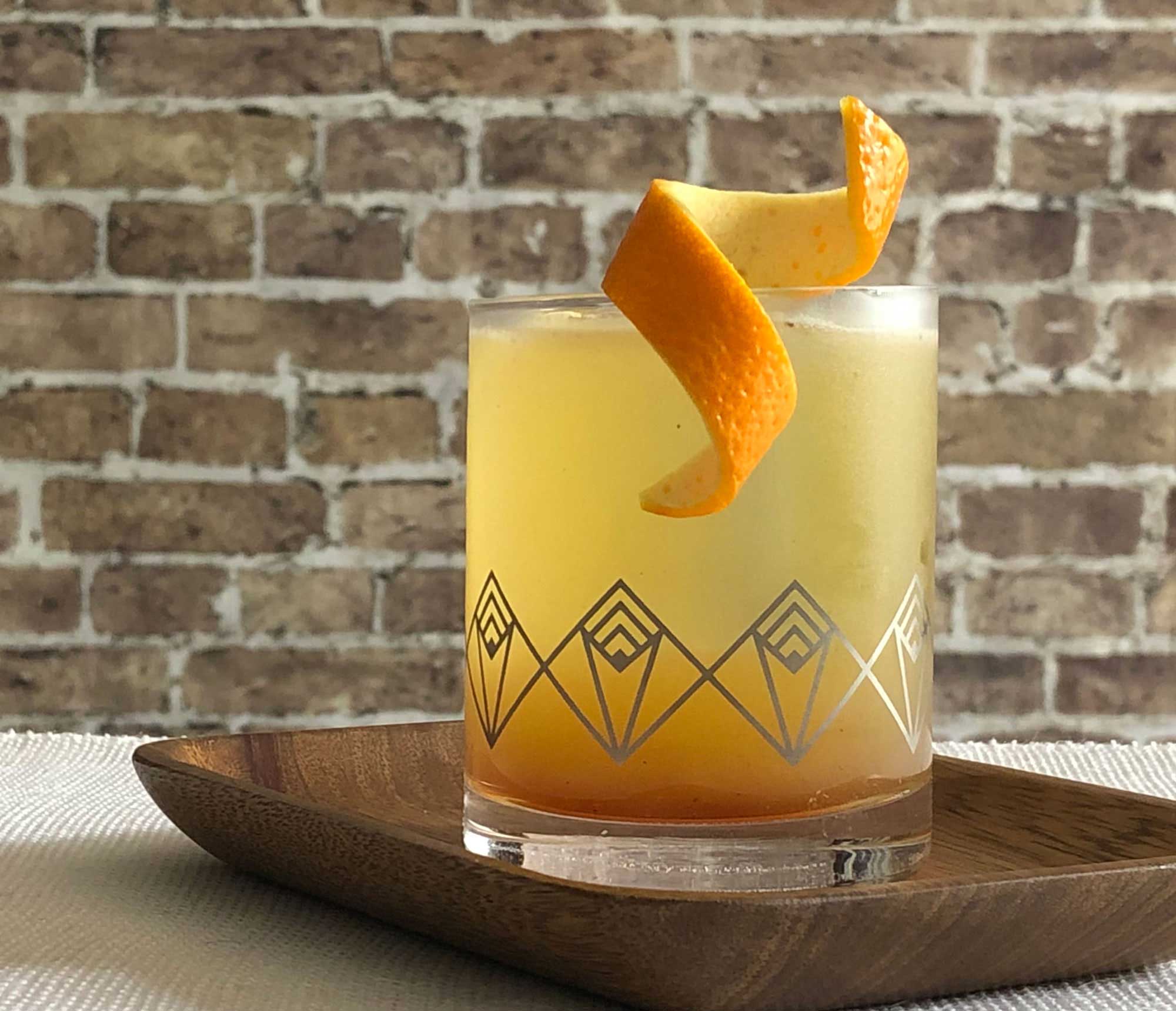 An example of the Prado 86, the mixed drink (cocktail), by Adam Hodak, Green Russell, Denver, featuring mezcal, orange-flavored liqueur, pineapple juice, orange juice, simple syrup, and St. Elizabeth Allspice Dram; photo by Lee Edwards