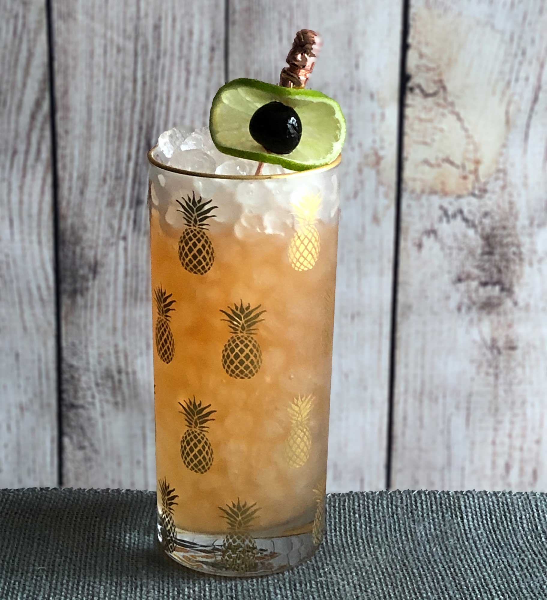 An example of the Rooibos Tea Punch, the mixed drink (punch), by based on a drink by Lauren Mote, Vancouver, BC, featuring ginger beer, The Scarlet Ibis Trinidad Rum, lime juice, John D. Taylor’s Velvet Falernum, rooibus syrup, and Angostura bitters; photo by Lee Edwards
