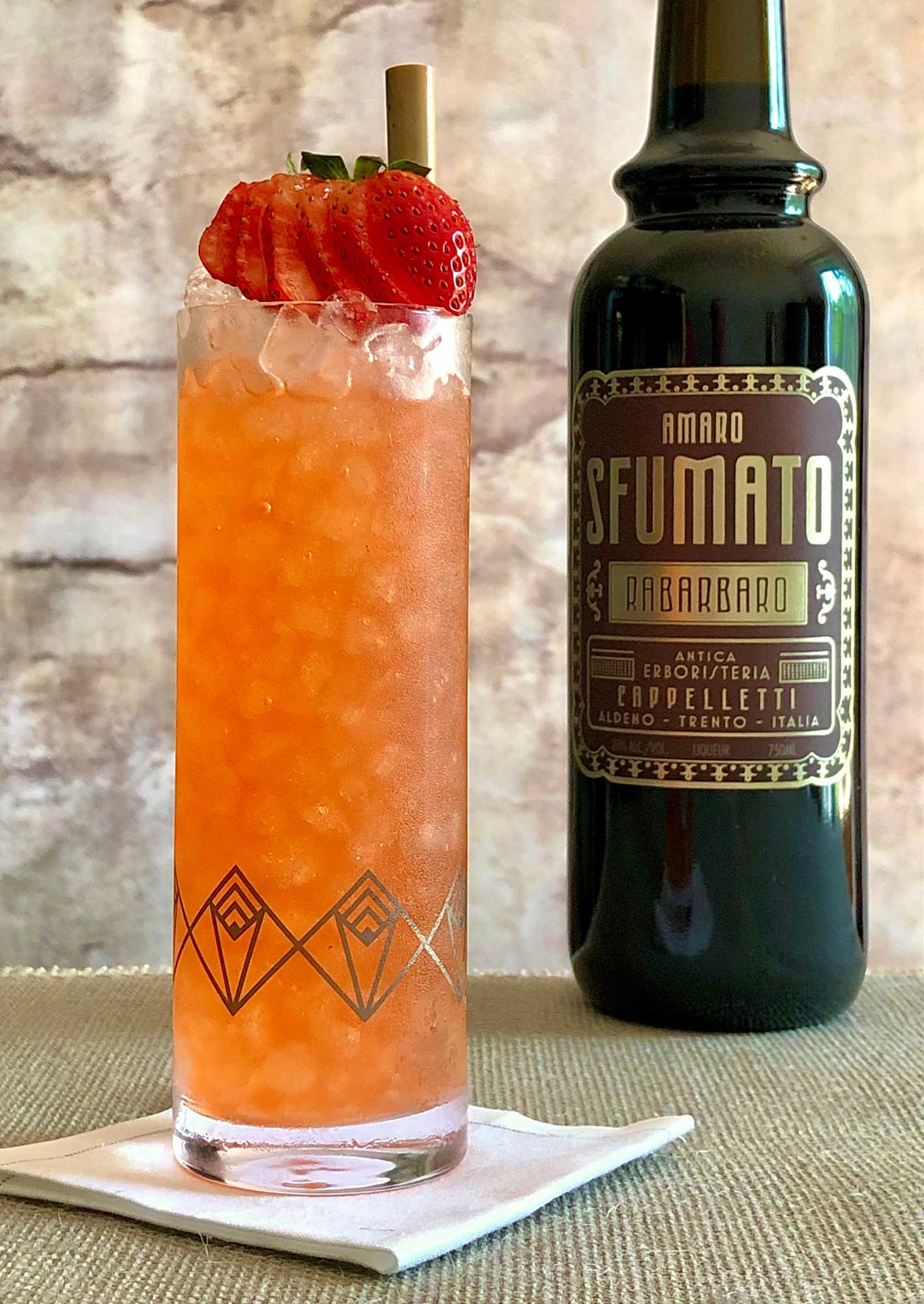 An example of the Lucky Duck Collins, the mixed drink (collins), by Kevin Bradel, Raines Law Room, NYC, featuring Plymouth Gin, seltzer, lemon juice, simple syrup, and Amaro Sfumato Rabarbaro; photo by Lee Edwards