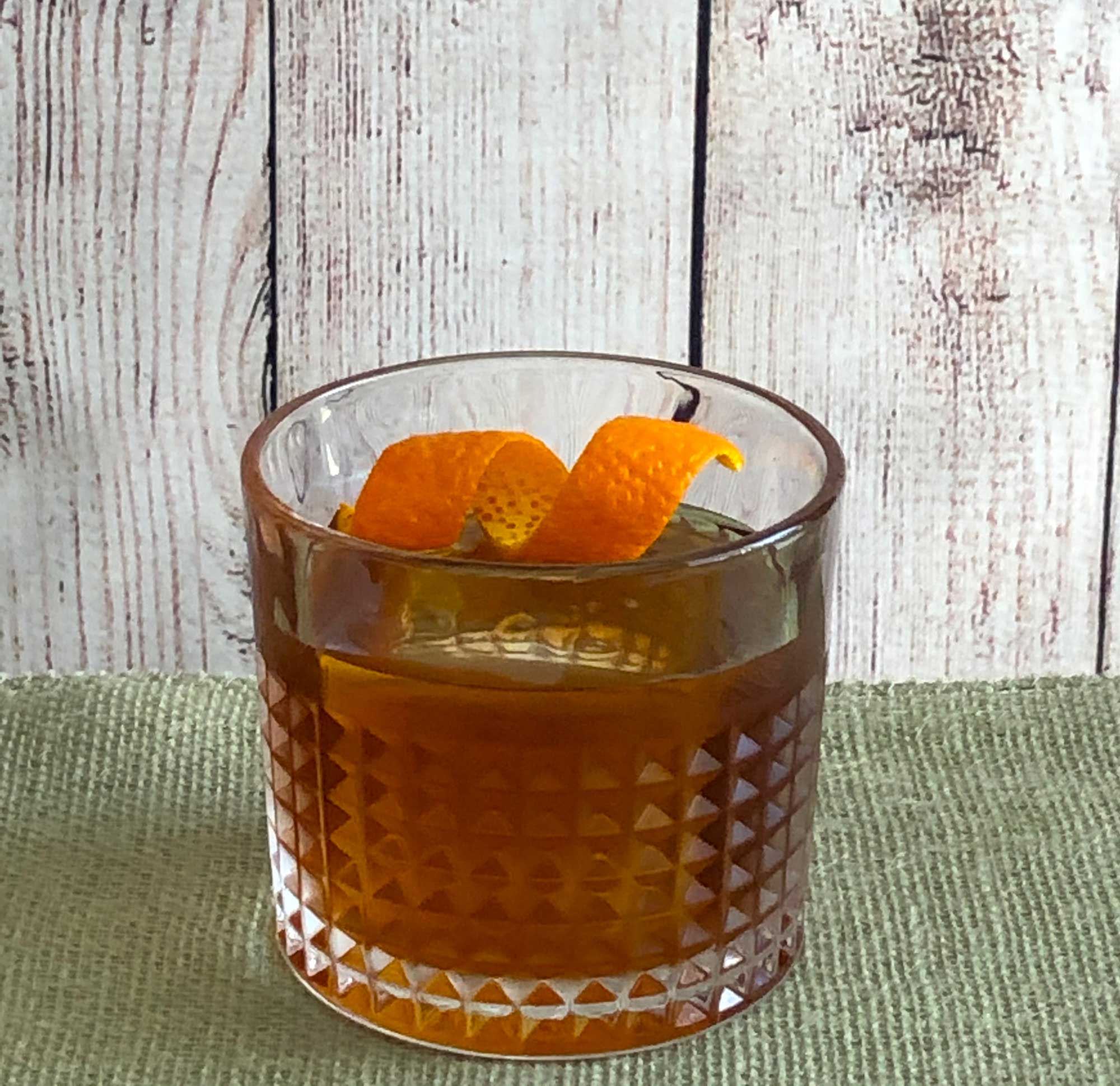 An example of the Negroni con Fumo, the mixed drink (cocktail) featuring Amaro Sfumato Rabarbaro, Hayman’s Royal Dock Navy Strength Gin, and Timbal Vermut de Reus Sweet Red; photo by Lee Edwards