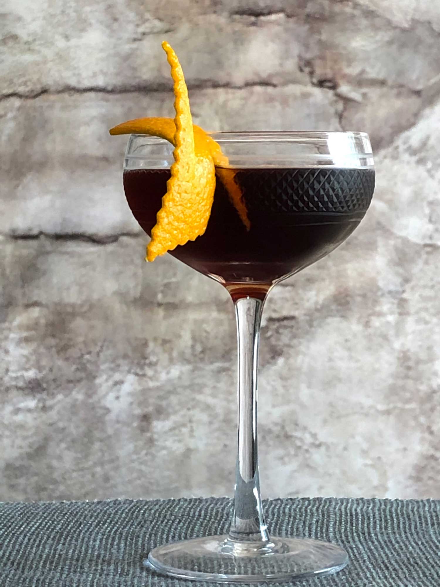 An example of the La Revuelta, the mixed drink (cocktail), by Lynn Falk, Acacia, Pittsburgh, featuring dark rum, Cocchi Dopo Teatro Vermouth Amaro, Amaro Sfumato Rabarbaro, and Bittermens Xocolatl Mole Bitters; photo by Lee Edwards