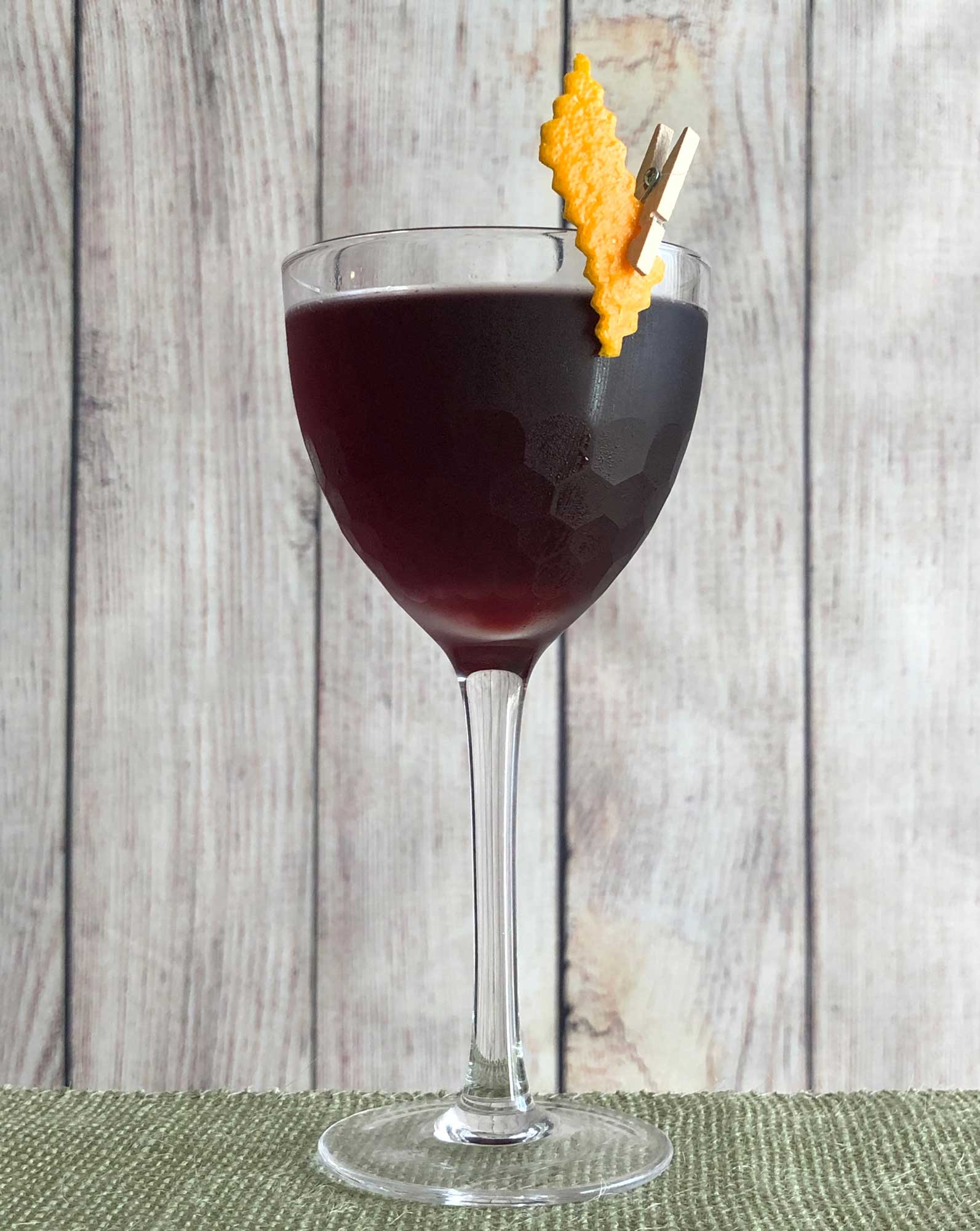 An example of the Aunt Cathy’s Old Time Potion, the mixed drink (cocktail) featuring dry red wine, Averell Damson Plum Gin Liqueur, Campari, orange bitters, and Fee Brothers Black Walnut Bitters; photo by Lee Edwards