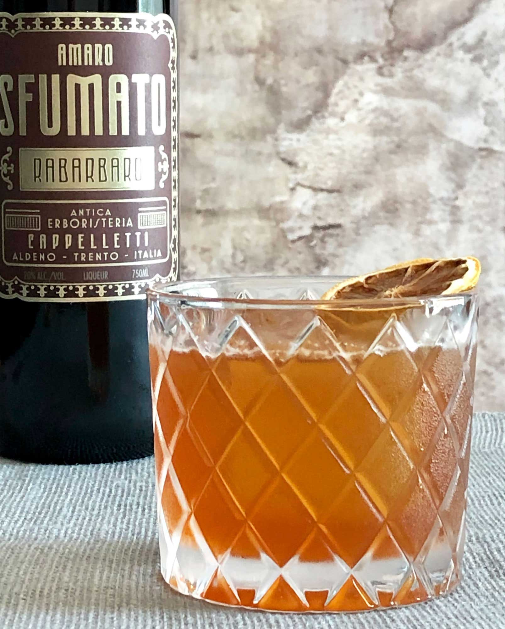 An example of the Welcome, Ghosts, the mixed drink (cocktail), by Nic Christiansen, Louisville, KY, featuring Copper & Kings Immature Brandy, Amaro Sfumato Rabarbaro, lemon juice, honey syrup, Angostura bitters, and chocolate bitters; photo by Lee Edwards