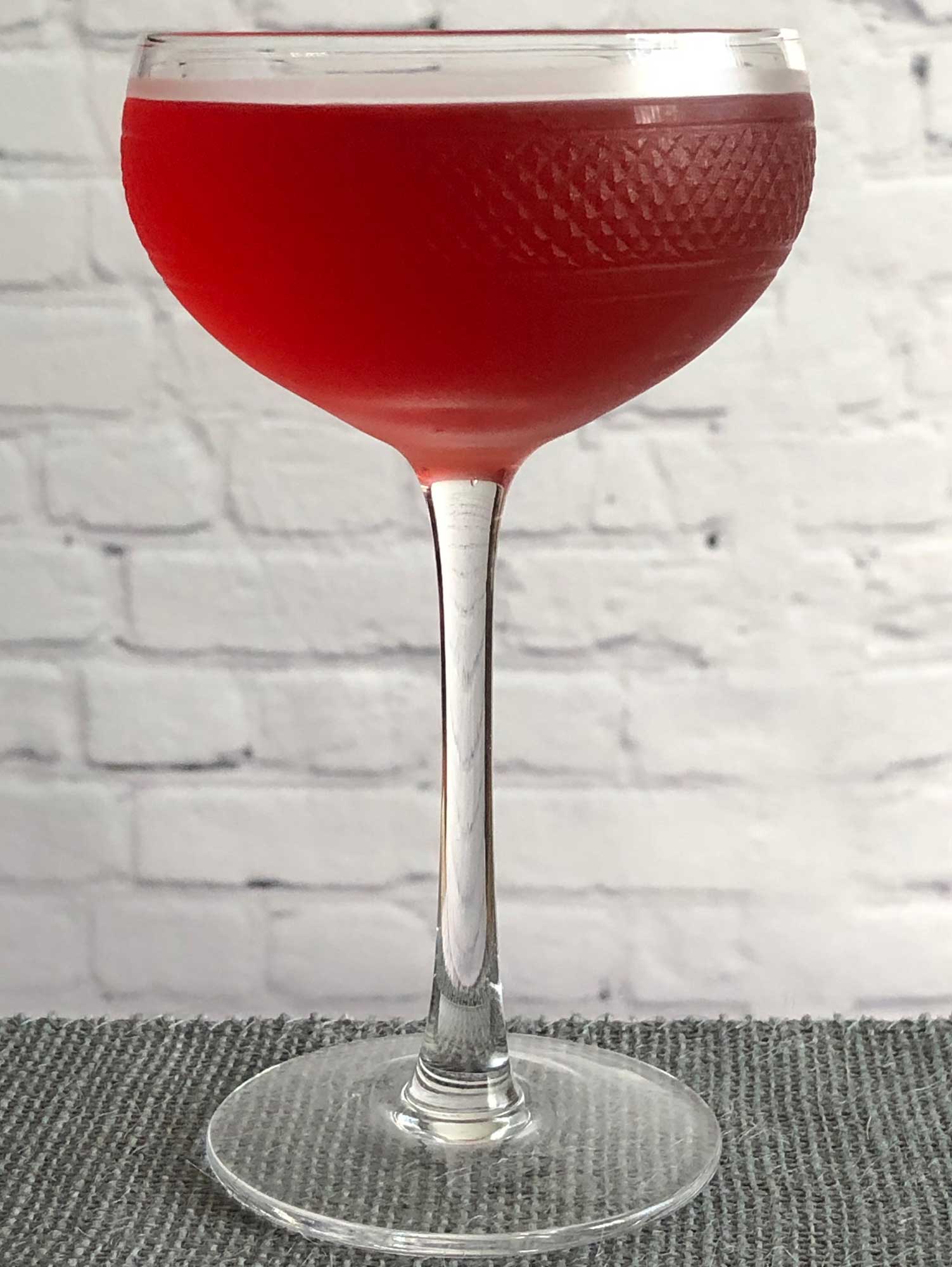 An example of the Grier and Now, the mixed drink (cocktail) featuring aquavit, Cocchi Americano Rosa, and Peychaud’s Aromatic Cocktail Bitters; photo by Lee Edwards