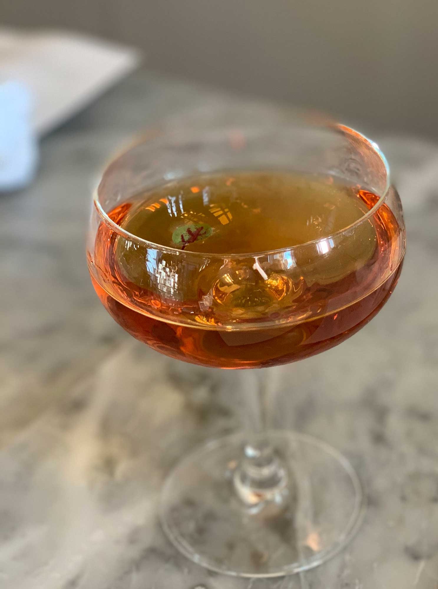 An example of the Into the Woods, the mixed drink (cocktail), by Lindsay Matteson, The Walrus and the Carpenter, Seattle, featuring Hayman’s London Dry Gin, Cocchi Americano Bianco, Zirbenz Stone Pine Liqueur of the Alps, Amaro Alta Verde, and Scrappy’s Aromatic Bitters