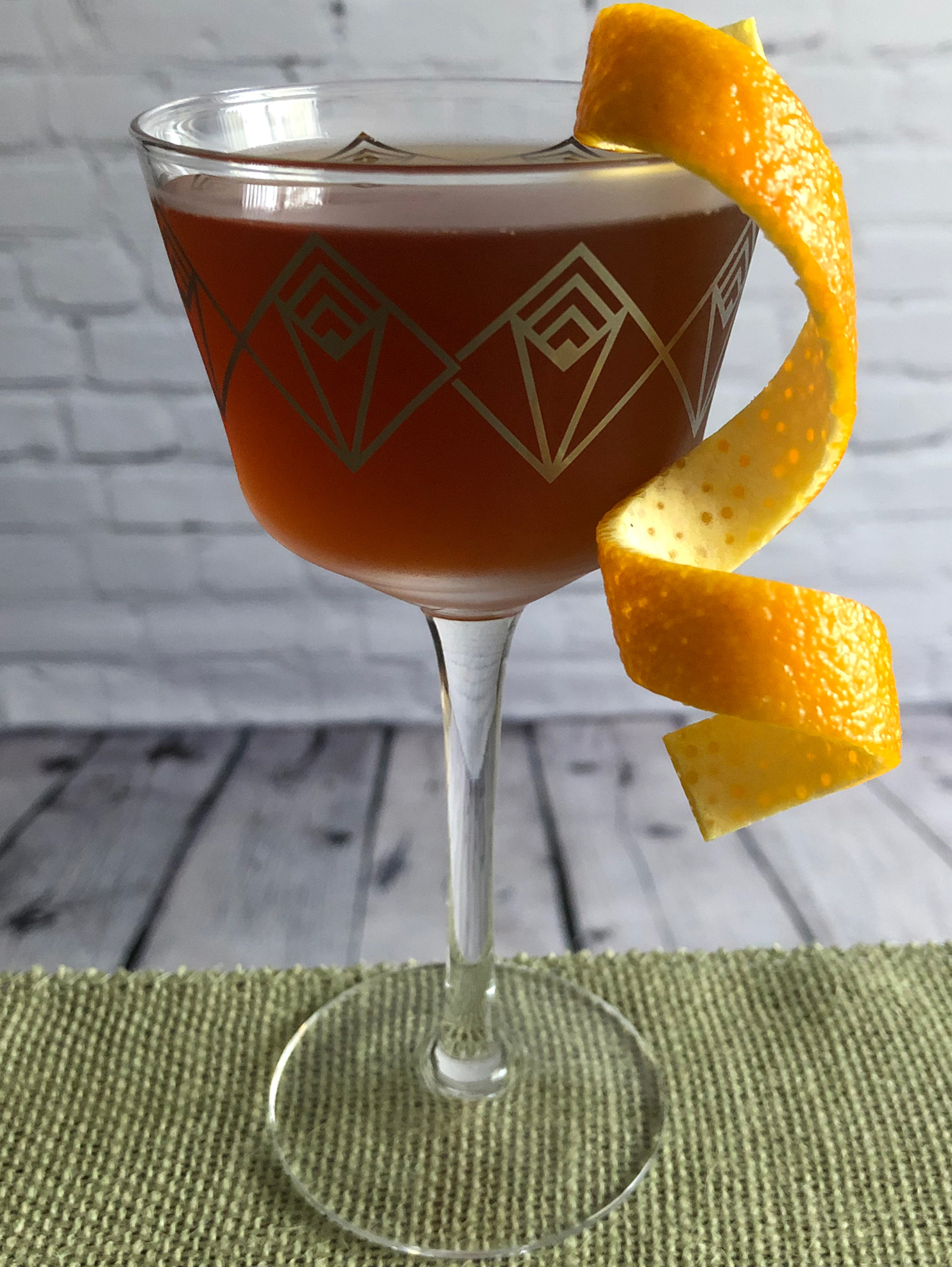 An example of the The Hammer, the mixed drink (cocktail) featuring Mattei Cap Corse Rouge Quinquina, bourbon whiskey, KRONAN Swedish Punsch, and orange bitters; photo by Lee Edwards