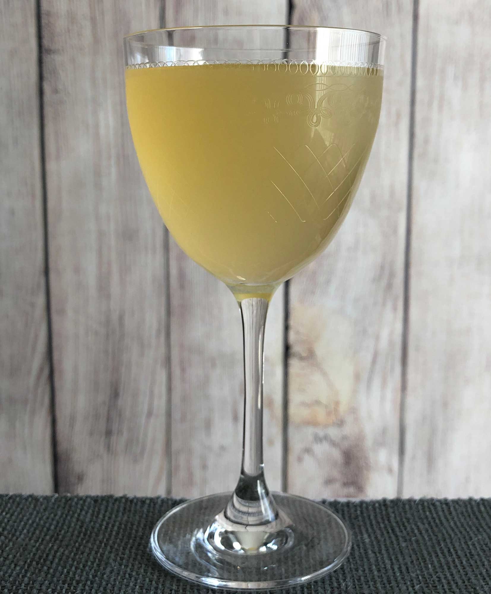 An example of the Flock Reviver, the mixed drink (cocktail), by Kelly O’Hare, Austin, TX, featuring Mattei Cap Corse Blanc Quinquina, Dolin Génépy le Chamois Liqueur, lemon juice, and The Scarlet Ibis Trinidad Rum; photo by Lee Edwards