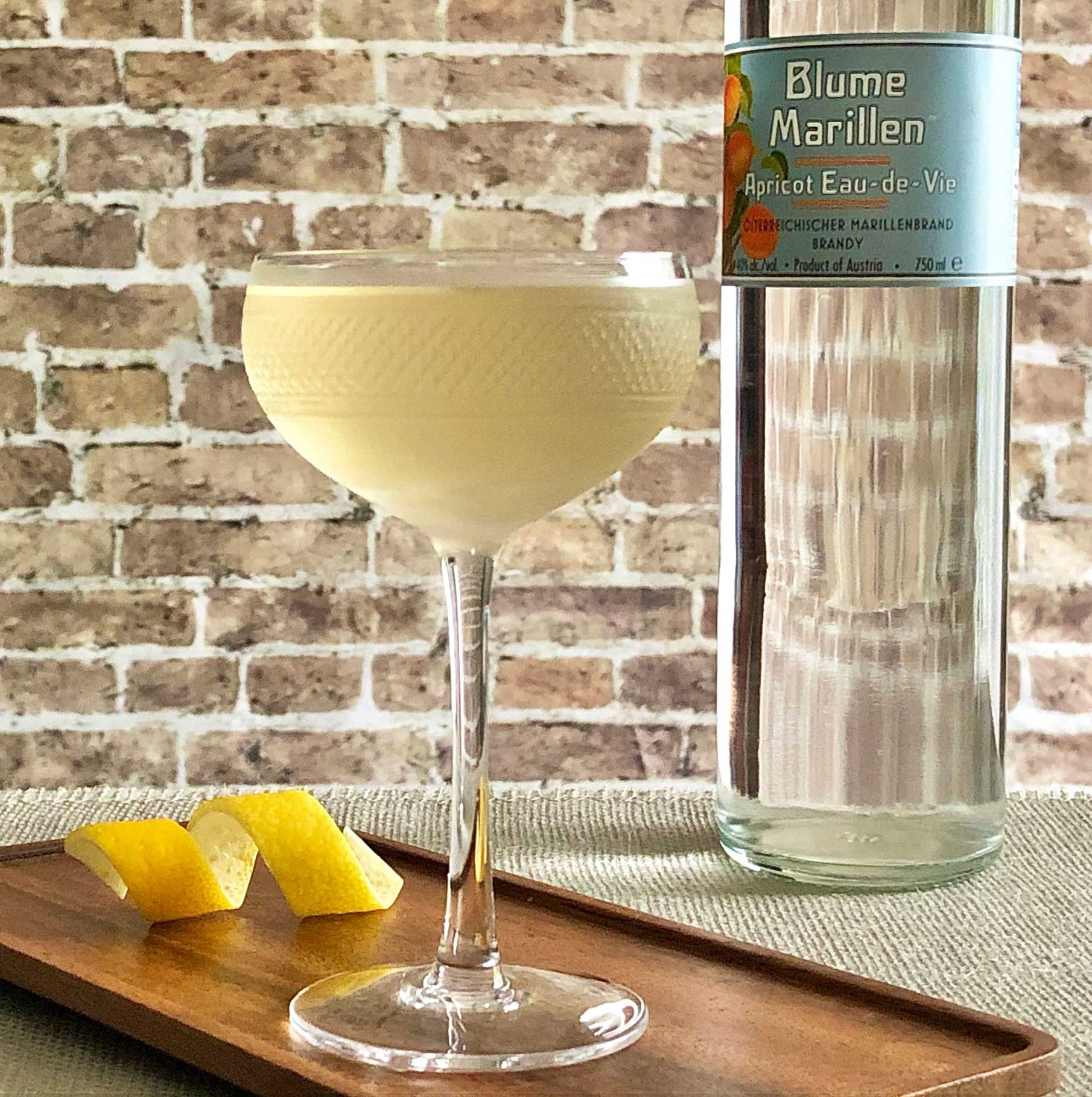 An example of the Gin Blossom, the mixed drink (cocktail), Adapted from Julie Reiner, NYC, featuring Hayman’s London Dry Gin, Dolin Blanc Vermouth de Chambéry, Blume Marillen Apricot Eau-de-Vie, and orange bitters; photo by Lee Edwards