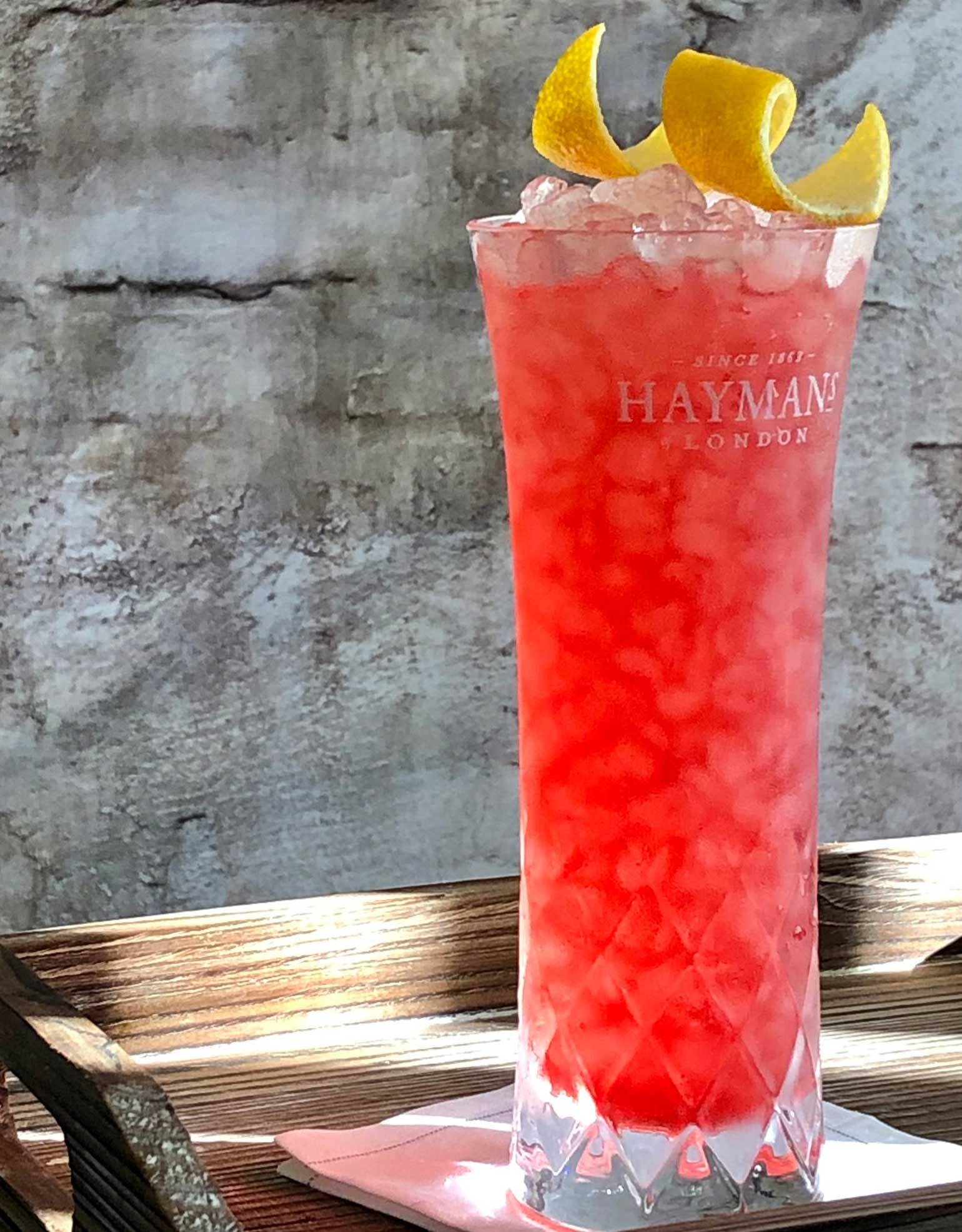 An example of the Elderberry Bramble, the mixed drink (cocktail), Adapted from Dick Bradsell, featuring Hayman’s London Dry Gin, lemon juice, rich simple syrup, and Rothman & Winter Orchard Elderberry Liqueur; photo by Lee Edwards